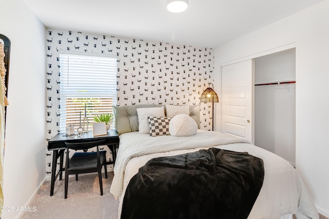 carpeted bedroom with baseboards and a closet