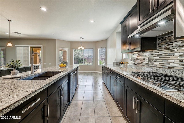 18207 W Sells Dr, Goodyear, AZ 85395 - kitchen with stainless steel gas cooktop, range hood, backsplash, light tile patterned flooring, and light stone counters