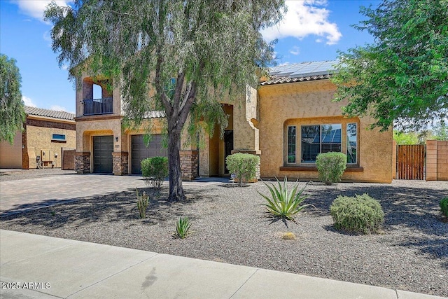 18207 W Sells Dr, Goodyear, AZ 85395 - view of front of home featuring an attached garage, solar panels, stucco siding, and a tiled roof