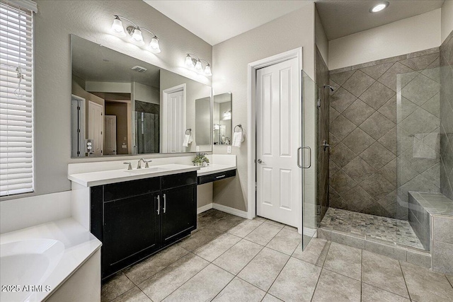 18207 W Sells Dr, Goodyear, AZ 85395 - bathroom featuring a shower stall, a garden tub, vanity, and tile patterned flooring