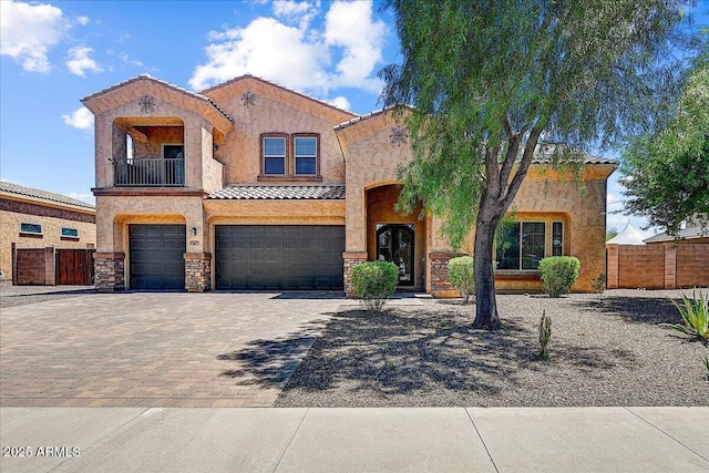 18207 W Sells Dr, Goodyear, AZ 85395 - mediterranean / spanish house featuring a tile roof, a garage, a balcony, stucco siding, and decorative driveway