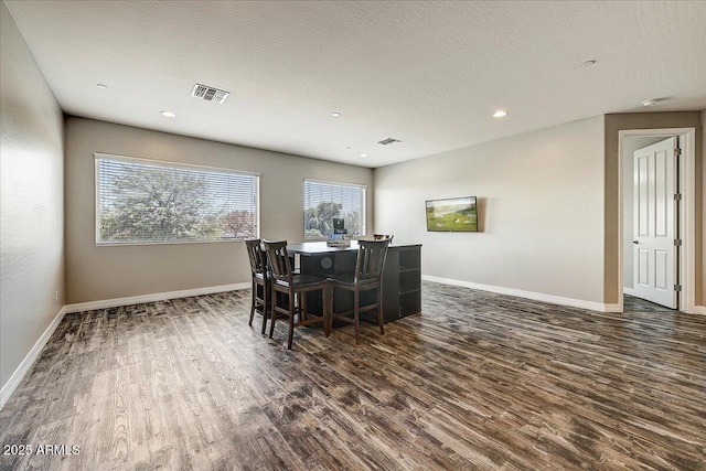 18207 W Sells Dr, Goodyear, AZ 85395 - dining room with dark wood-style floors, recessed lighting, and a textured ceiling