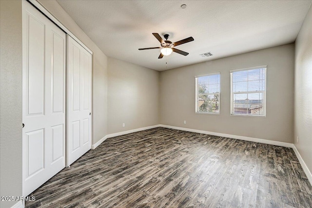 18207 W Sells Dr, Goodyear, AZ 85395 - unfurnished bedroom with dark wood-type flooring, a closet, and ceiling fan