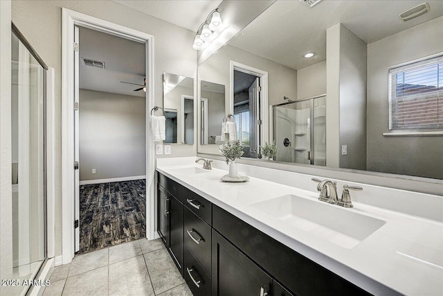 18207 W Sells Dr, Goodyear, AZ 85395 - bathroom featuring double vanity, a shower stall, tile patterned floors, and ceiling fan