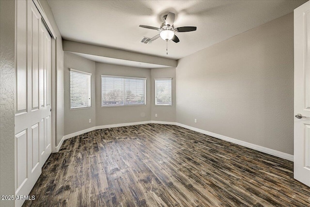 18207 W Sells Dr, Goodyear, AZ 85395 - unfurnished bedroom featuring dark wood finished floors and a ceiling fan
