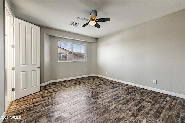18207 W Sells Dr, Goodyear, AZ 85395 - unfurnished bedroom featuring dark wood-type flooring and ceiling fan