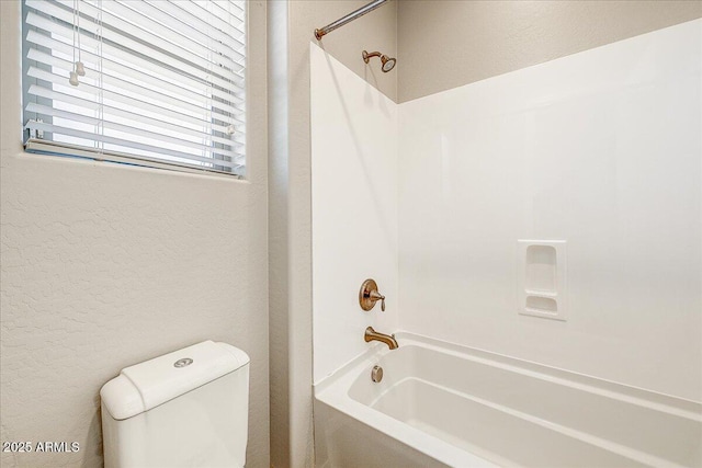 18207 W Sells Dr, Goodyear, AZ 85395 - bathroom featuring shower / tub combination and a textured wall