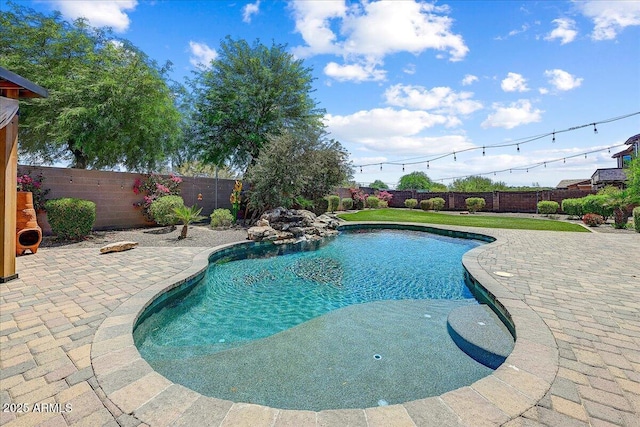 18207 W Sells Dr, Goodyear, AZ 85395 - view of swimming pool featuring a patio and a fenced backyard