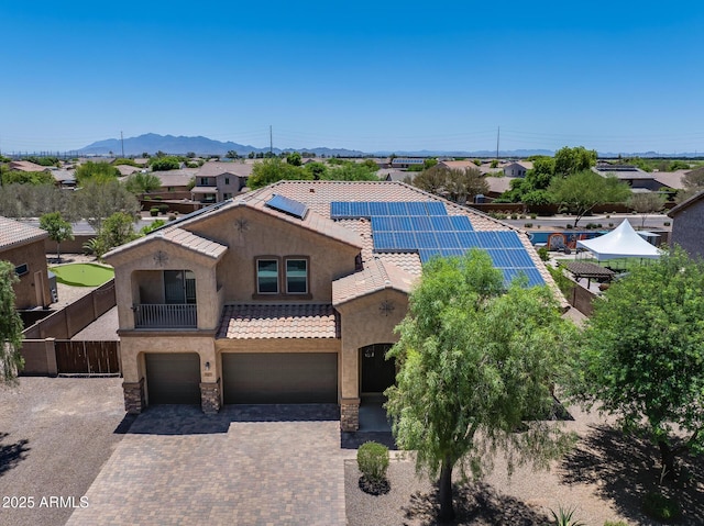 18207 W Sells Dr, Goodyear, AZ 85395 - view of front of property with a garage, a mountain view, stucco siding, a tile roof, and roof mounted solar panels