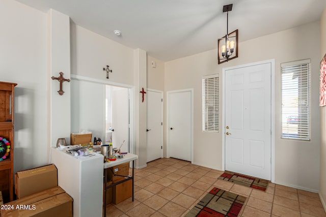 entryway featuring light tile patterned flooring and a chandelier