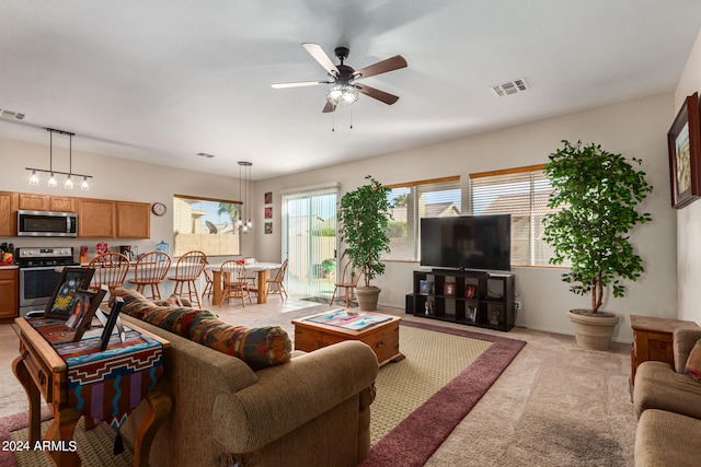 living room with ceiling fan and light colored carpet