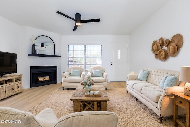 living room with light hardwood / wood-style floors and ceiling fan