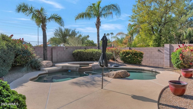 view of swimming pool featuring an in ground hot tub