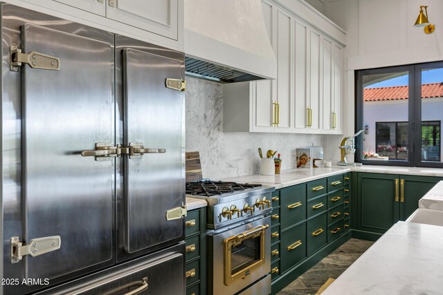2339 E Virgo Pl, Chandler, AZ 85249 - kitchen featuring green cabinets, high quality appliances, custom exhaust hood, white cabinets, and decorative backsplash