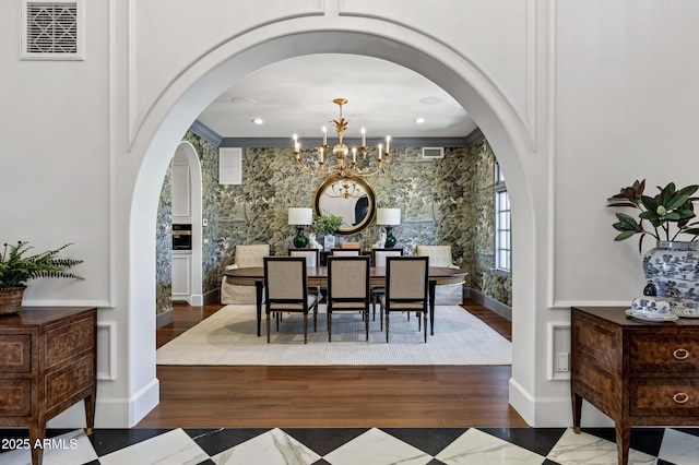 2339 E Virgo Pl, Chandler, AZ 85249 - dining room featuring arched walkways, a chandelier, wood finished floors, and baseboards