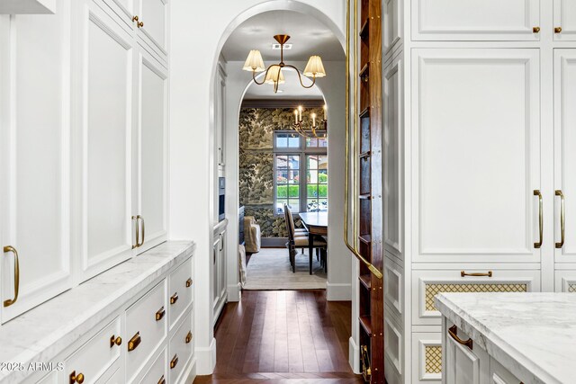 2339 E Virgo Pl, Chandler, AZ 85249 - entrance foyer with a chandelier, arched walkways, dark wood-type flooring, and a decorative wall