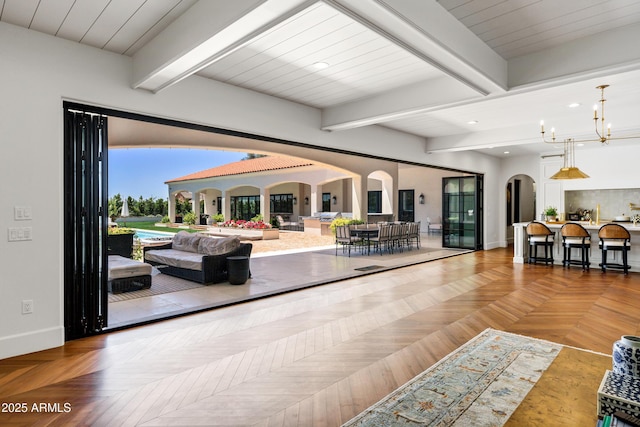2339 E Virgo Pl, Chandler, AZ 85249 - living room featuring arched walkways, baseboards, beam ceiling, and recessed lighting