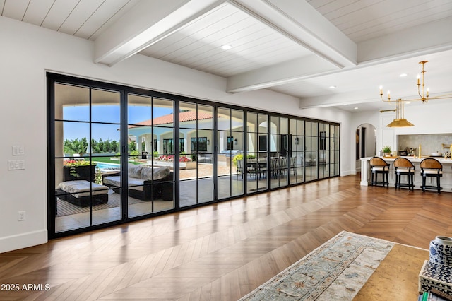 2339 E Virgo Pl, Chandler, AZ 85249 - living room with baseboards, arched walkways, beamed ceiling, recessed lighting, and a chandelier