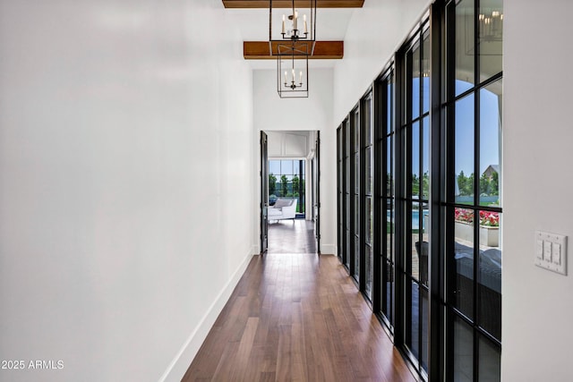 2339 E Virgo Pl, Chandler, AZ 85249 - hallway featuring baseboards, a high ceiling, dark wood finished floors, and a chandelier