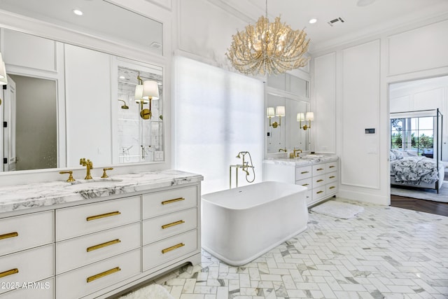 2339 E Virgo Pl, Chandler, AZ 85249 - bathroom with a decorative wall, a chandelier, a freestanding tub, recessed lighting, and two vanities