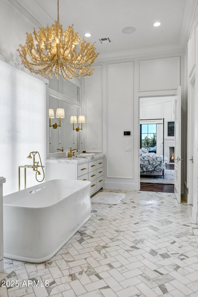 2339 E Virgo Pl, Chandler, AZ 85249 - ensuite bathroom with a chandelier, a decorative wall, a freestanding bath, vanity, and recessed lighting