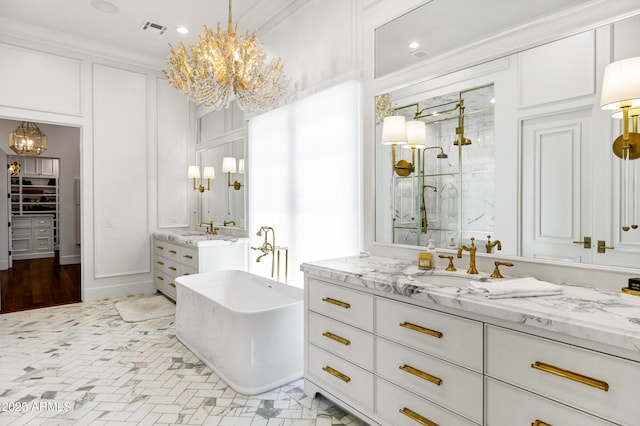 2339 E Virgo Pl, Chandler, AZ 85249 - bathroom featuring a chandelier, a shower stall, a freestanding bath, two vanities, and recessed lighting