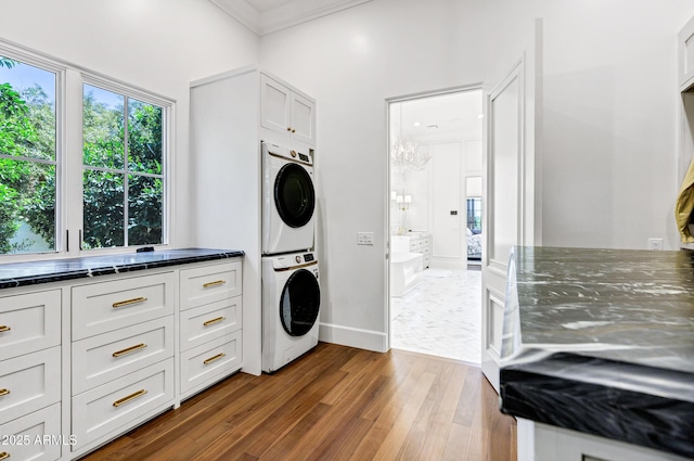 2339 E Virgo Pl, Chandler, AZ 85249 - clothes washing area with stacked washer / drying machine, wood finished floors, crown molding, and baseboards