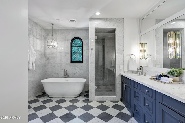 2339 E Virgo Pl, Chandler, AZ 85249 - full bath with vanity, a shower stall, a soaking tub, a chandelier, and tile walls
