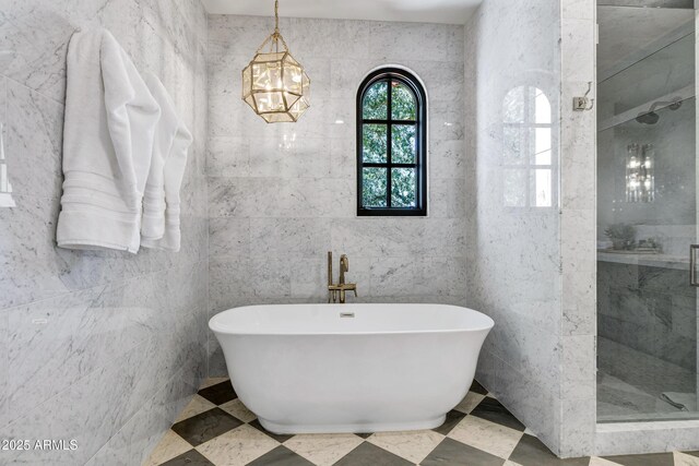 2339 E Virgo Pl, Chandler, AZ 85249 - full bath with a shower stall, a soaking tub, a chandelier, and tile walls
