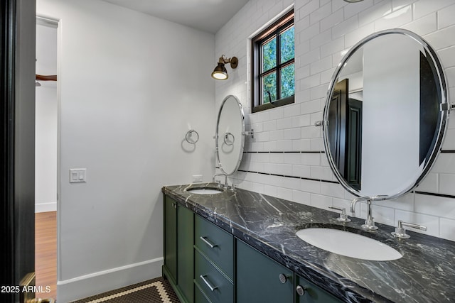 2339 E Virgo Pl, Chandler, AZ 85249 - bathroom featuring backsplash, double vanity, baseboards, and tile walls