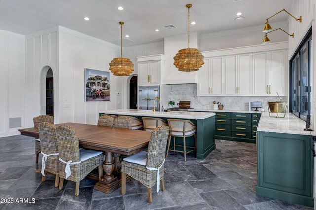 2339 E Virgo Pl, Chandler, AZ 85249 - dining area with arched walkways, recessed lighting, a chandelier, and a decorative wall