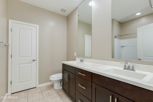 bathroom featuring double vanity, visible vents, a sink, and tile patterned floors