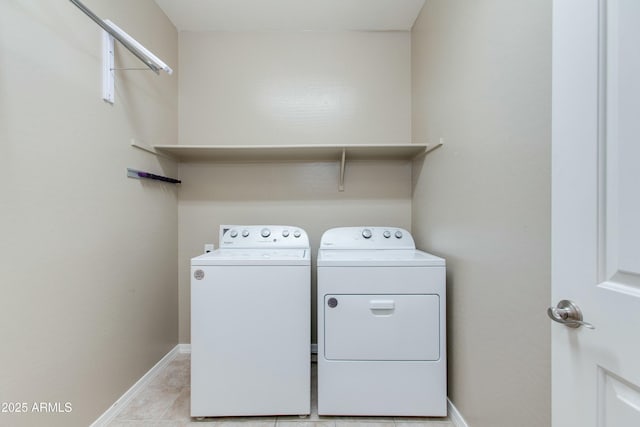 laundry area featuring laundry area, baseboards, and washing machine and clothes dryer