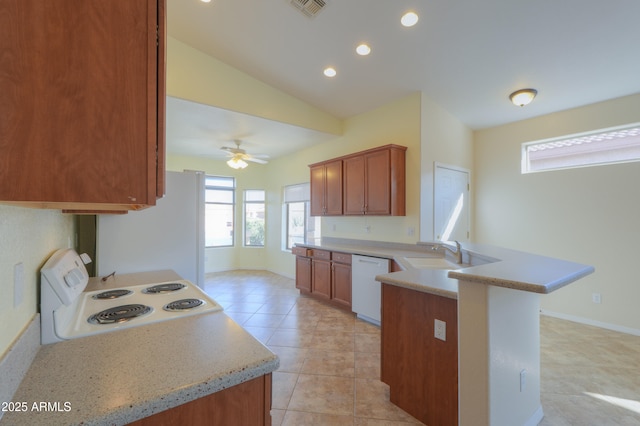 kitchen with ceiling fan, vaulted ceiling, kitchen peninsula, sink, and white appliances