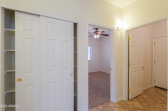 hallway with light colored carpet