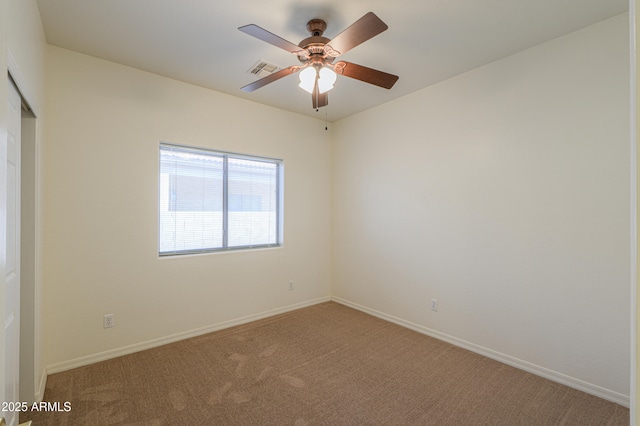 empty room featuring carpet floors and ceiling fan