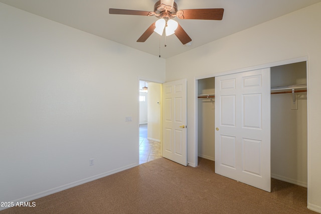 unfurnished bedroom featuring light carpet, a closet, and ceiling fan