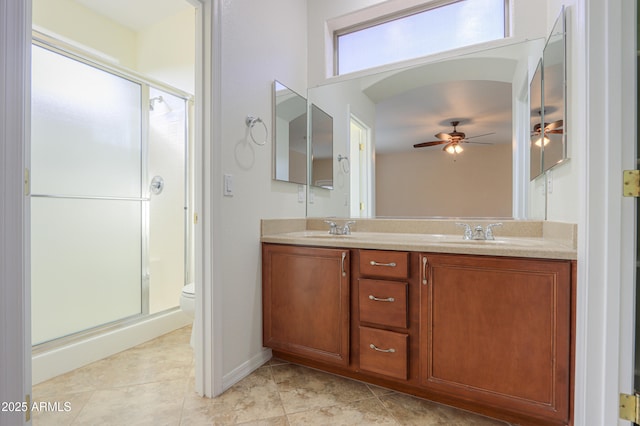 bathroom with ceiling fan, vanity, an enclosed shower, and toilet