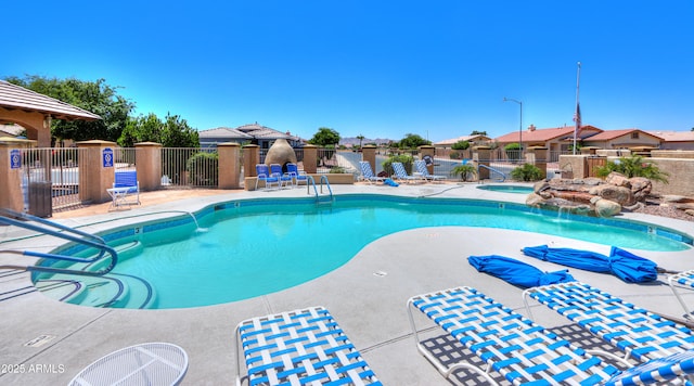 view of pool featuring a hot tub and a patio area