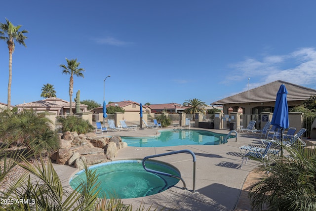 view of swimming pool featuring a patio area and a community hot tub