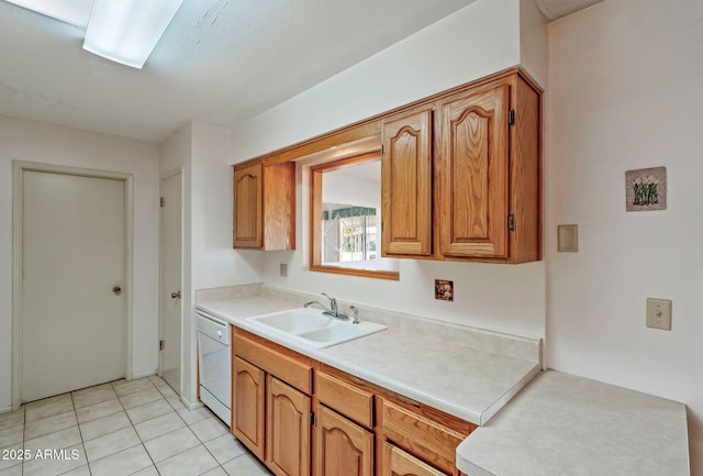 kitchen featuring light tile patterned flooring, white dishwasher, and sink