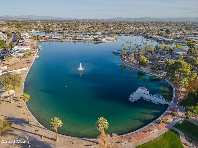 drone / aerial view with a water and mountain view