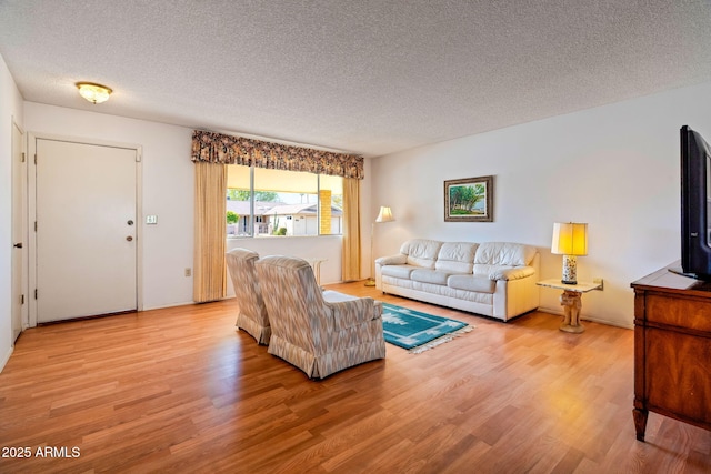 living room with light hardwood / wood-style flooring and a textured ceiling