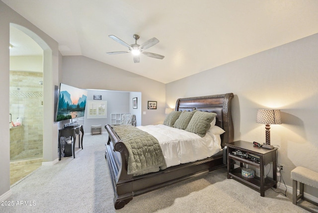 bedroom with carpet, vaulted ceiling, arched walkways, baseboards, and a ceiling fan
