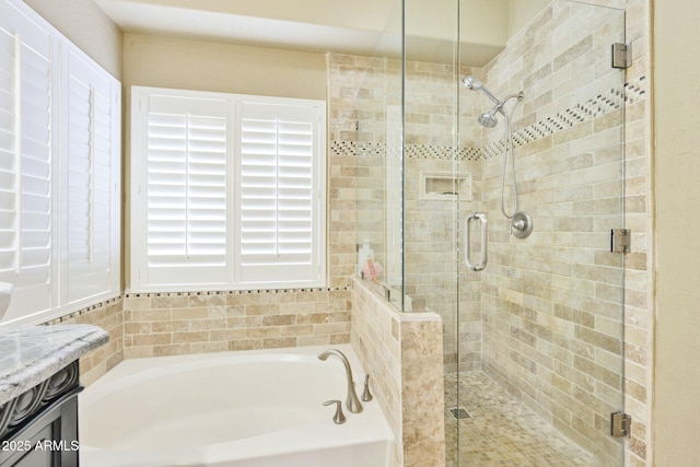 full bath featuring a garden tub and a stall shower