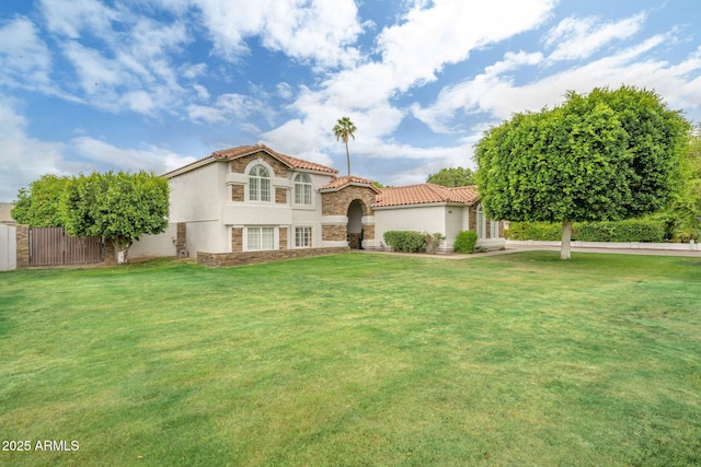 mediterranean / spanish-style home featuring stone siding, stucco siding, and a tiled roof