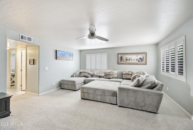living room featuring ceiling fan, carpet floors, and baseboards