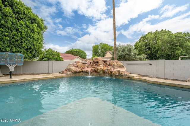 view of swimming pool with a fenced backyard