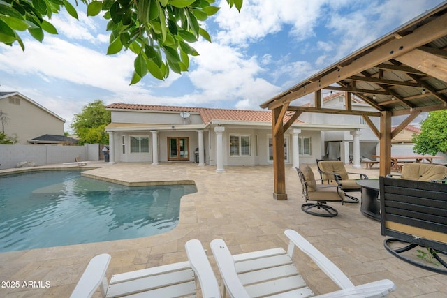 view of pool with fence, a patio area, and french doors