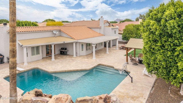 swimming pool with a gazebo, a grill, and a patio area